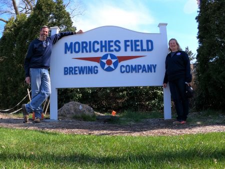 Finished corner sign with the Moriches Field Brewing Company logo and owners.