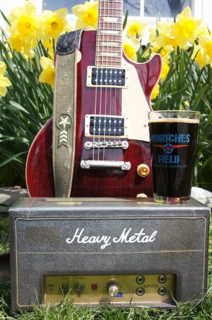 A guitar, an American porter and daffodils in the back ground